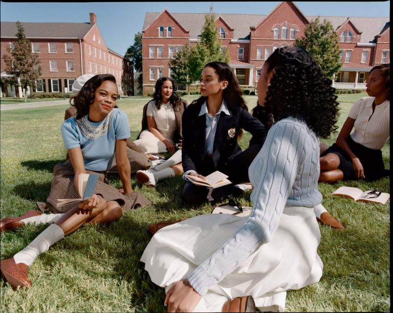 modern day black women sitting down on university campus grounds. Dressing well
