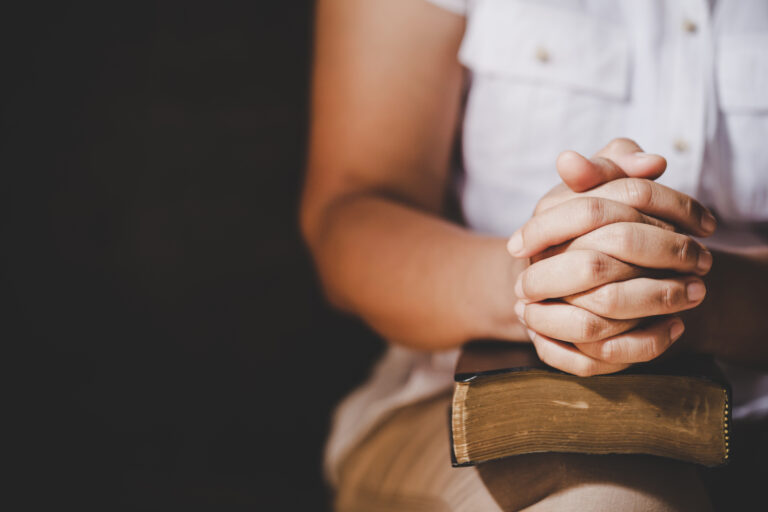 single woman with bible praying. Single women