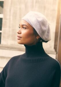 Black woman wearing grey beret