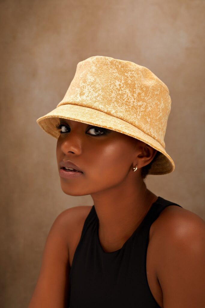 black woman wearing a yellow cloche hat